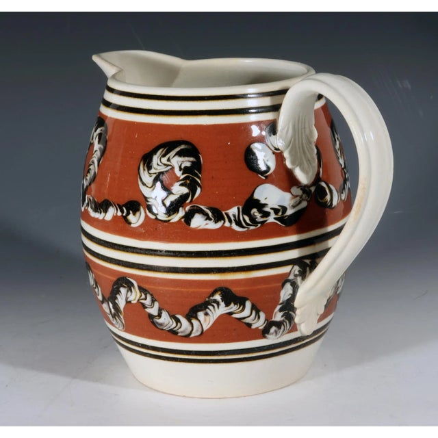 Antique English Mocha Pottery Earthworm Jug, Circa 1820 This early nineteenth-century English mocha pottery jug carries...