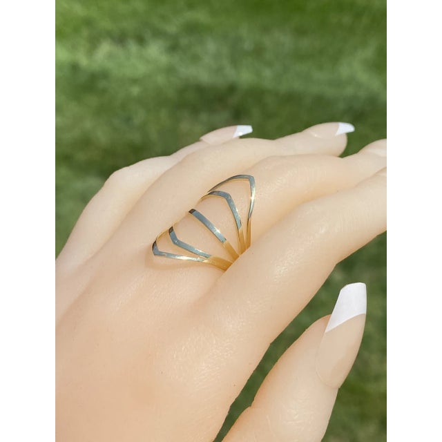 The School Lane: Yellow Gold Cocktail Statement Ring. The ring features five rows of polished gold in a chevron shape to...
