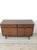 This mid century modern lowboy dresser features hardwood construction, original walnut finish, six dovetailed drawers with...