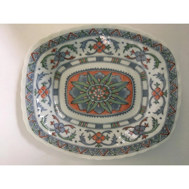 Offering a shallow, porcelain, rectangular bowl with scalloped edges. This is a lovely salmon and blue on white floral &...