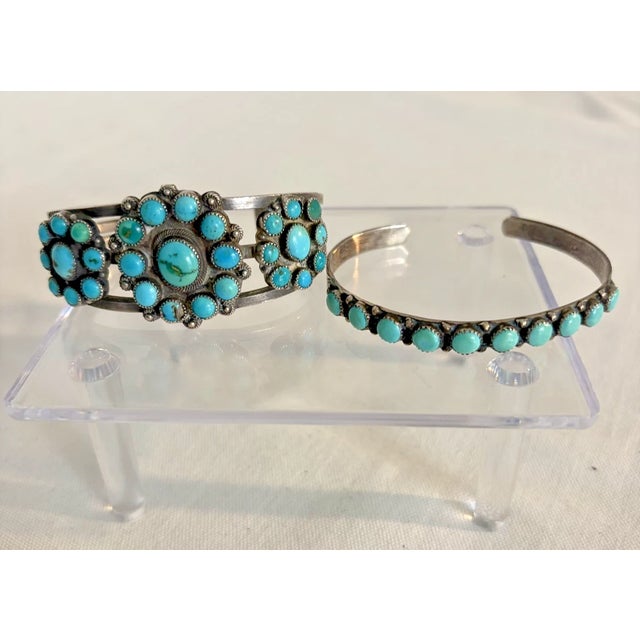 This Zuni Turquoise and Silver Bracelet Set Includes a bracelet of three flowers set on an engraved silver band. The...