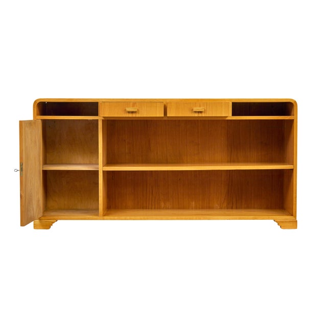 Mid-Century Scandinavian Elm Low Open Bookcase Sideboard, Circa 1950 An elegant piece of Swedish design with flowing lines...