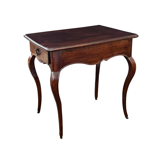 the solid beechwood frame of pegged construction featuring a rectangular top with molded edge over scalloped apron fitted...