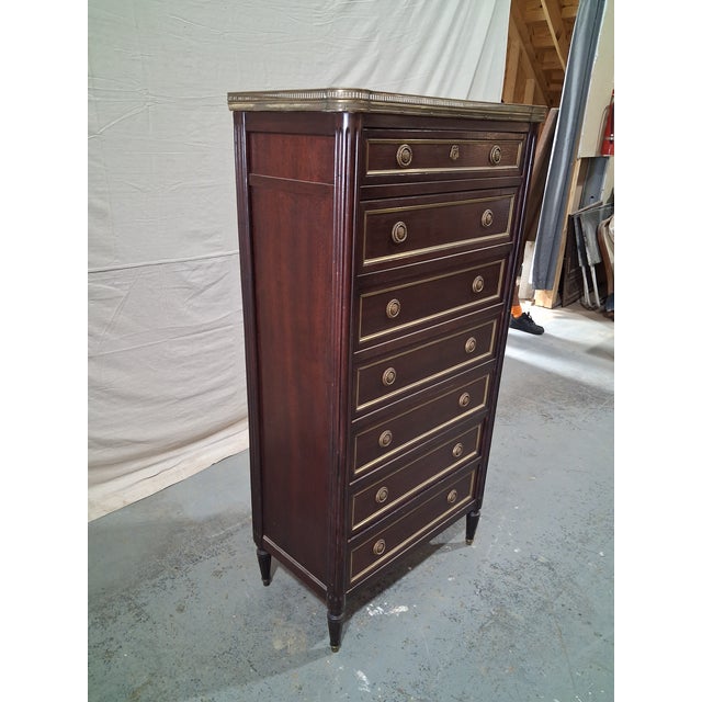 An elegant mid 19th-century French Louis XVI style semainier (weekly chest) crafted in richly figured mahogany and topped...