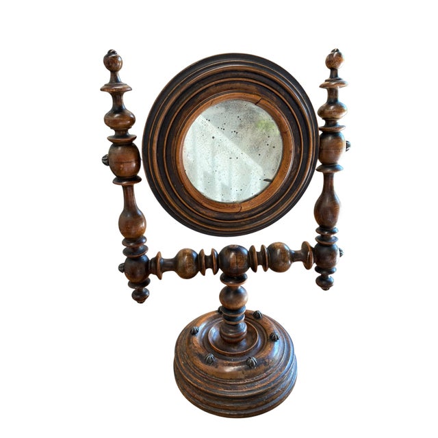 A charming late 19th-century Victorian walnut swivel mirror, beautifully crafted with turned spindle supports and a rich,...