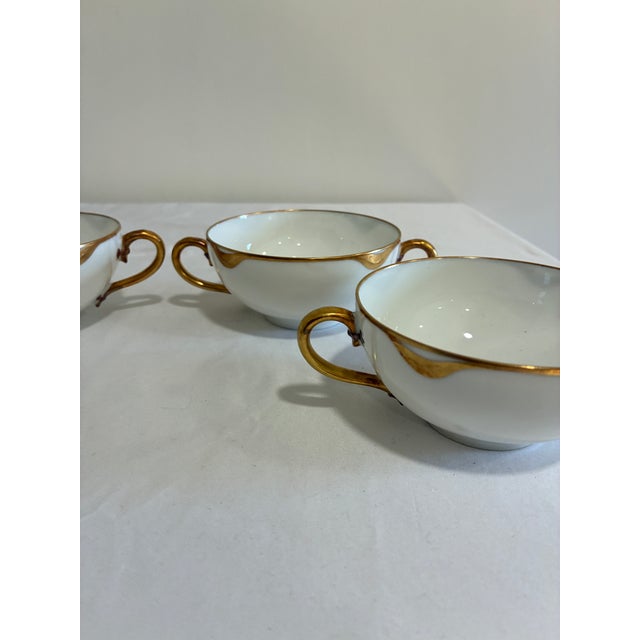 set of 4 antique Haviland & Co. Limoges bouillon cups in fine white porcelain with gilded rims and elegant double handles....