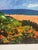 This vibrant coastal landscape bursts with color and energy. Bold brushstrokes capture a hillside of California poppies...