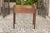An English Georgian period oak side table from the late 18th century, with three drawers, chinoiserie hardware and...