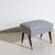 Small mid-century stool raised on splayed tapered wooden legs with brass sabots. Newly upholstered in black and white...