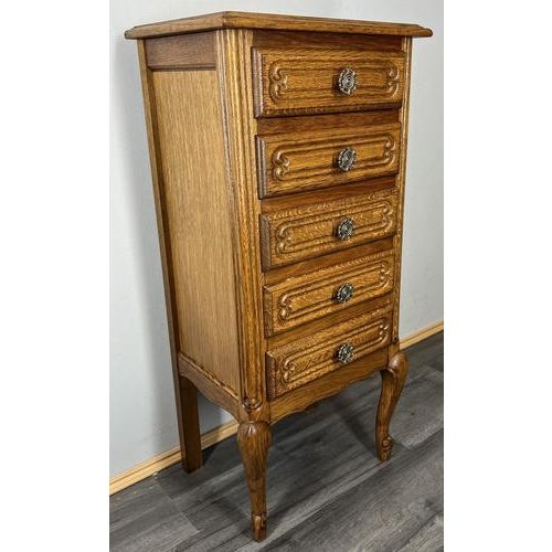This charming Vintage French Louis style tall chest of drawers combines elegance and practicality with its refined carved...