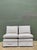 A pair of vintage slipper chairs upholstered in classic ticking stripe fabric, likely hailing from the mid-20th century....