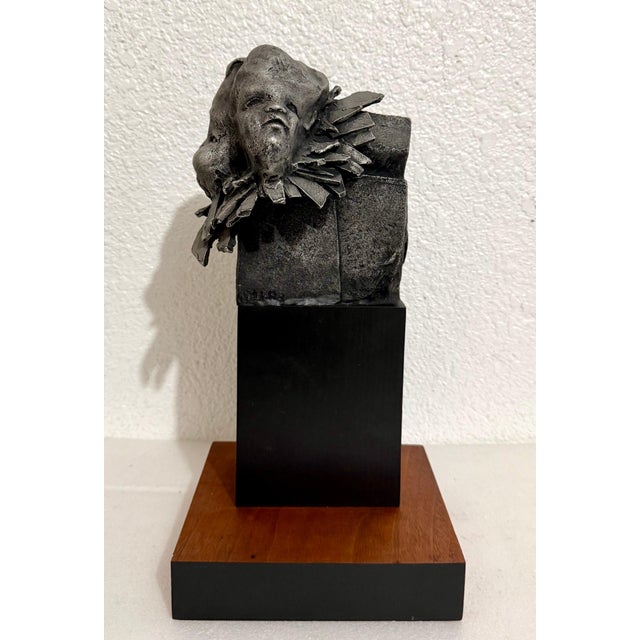 Cast metal on a wood plinth base Signed in cast at side with illegible name or initials This is being sold as attributed...