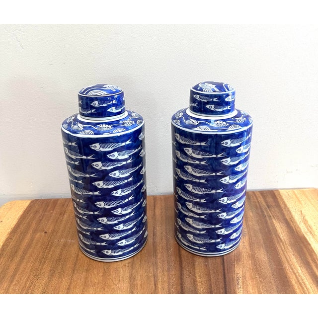 Set of two Schoal Blue and White Ceramic Fish Detail Lidded Ginger Jar, a Chinoiserie-style decorative vessel featuring a...