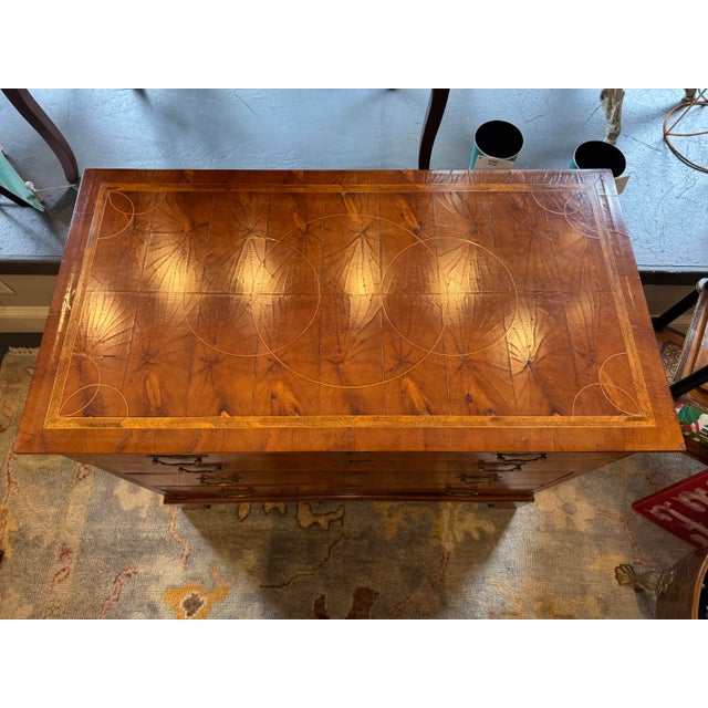This is an antique chest of drawers. It is George III style. It is Burled walnut. It has brass hardware. It has four...