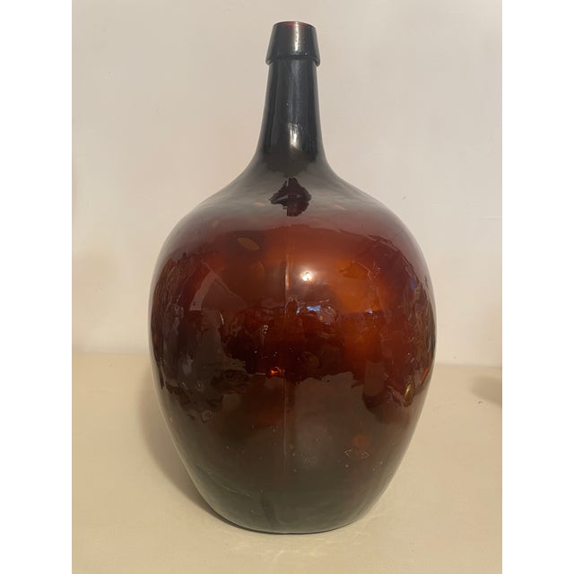This is a traditional French demijohn (carboy) originally used for transporting and storing wine in the late 19th and...