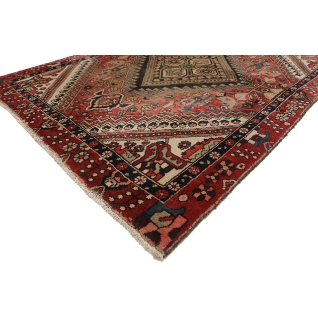 Vintage Persian Shiraz rug with rustic traditional style. This hand knotted wool vintage Persian Shiraz rug features a...
