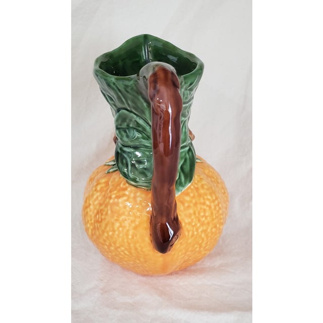 Bring vibrant Mediterranean charm to your home with this **Olfaire Pottery Textured Ceramic Orange Fruit Shaped Pitcher**,...