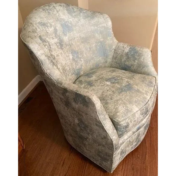 Brand new Swaim modern swivel chair in a blue and green abstract fabric. Gracefully shaped back and arm design. Spring...
