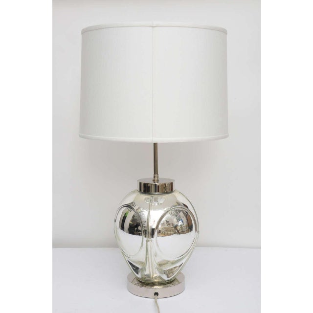 This handsome, polished chrome and mercury-glass table lamp dates from the 1970s with there optic-bubble detail. Shade not...