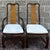 A pair of Universal Furniture Asian Mings style dining chairs including one armchair and one side chair. They feature dark...