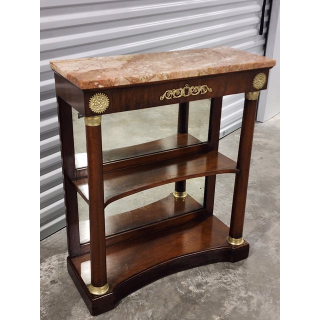 Antique Empire style early 20th century Mahagony console table with pink Italian marble top and mirrored back. The console...