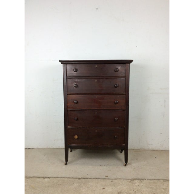 This antique Depression era chest of drawers features hardwood construction, five dovetailed drawers with turned wood...
