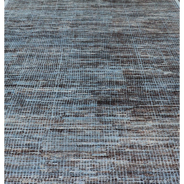 Afghanistan made rug in Various blues and charcoal colors in hi-low texture and free-flowing tribal design, Keivan Woven...