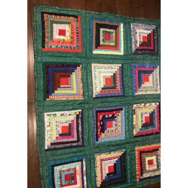 Green satin log cabin quilt in pristine condition. The backing is in a baby blue shambrae cotton fabric.