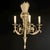 An impressive and richly decorative wall sconce in the French neoclassical style, featuring an elegant three-arm design....