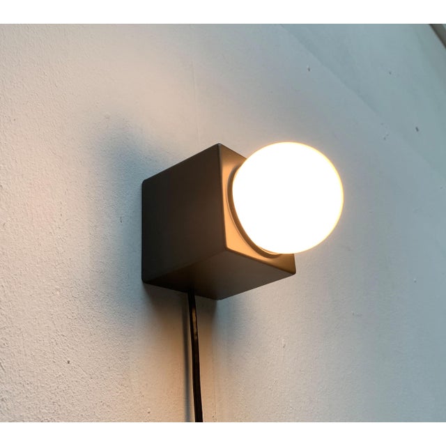 Minimalist table or wall light from philips. a simple design in cubic form. The actual luminaire body is a cubic base that...