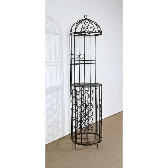 Wrought iron bottle bar consisting of a half-circle upper part. There is a structure for hanging on foot glasses and a...