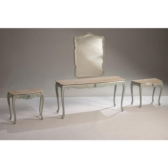 Elegant set consisting of a dressing table with mirror and two matching bedside tables. Crafted in lacquered wood with a...