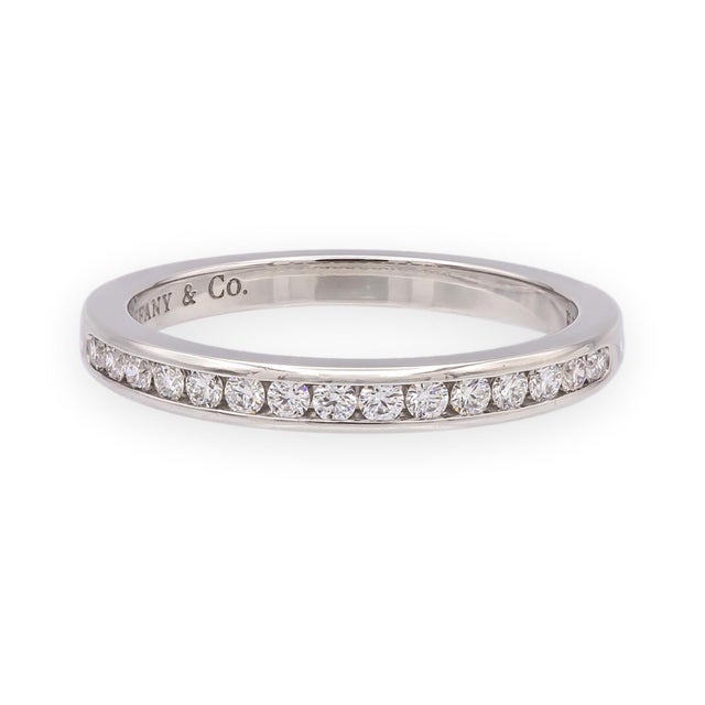 Tiffany & Co. platinum half-circle band set with 15 round brilliant diamonds in a channel setting, totaling approximately...