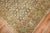 An earth color 1930s Persian herati design Rug highlighted by coral and chartreuse accent colors
