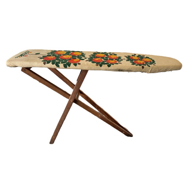 This rare antique ironing board from the early 1900s is a unique piece with a torpedo shape and a charming orange tree...