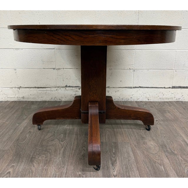 This is a stunning antique Mission / Arts & Crafts dining table crafted from solid quarter-sawn tiger oak. Features a...