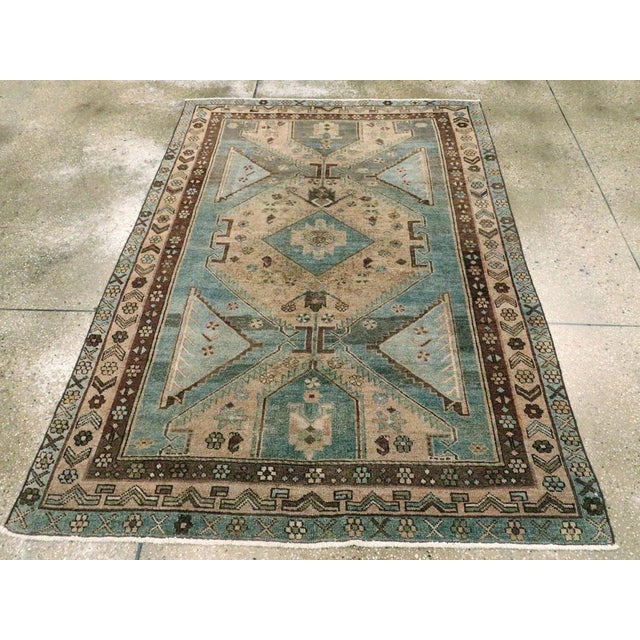 An antique Persian Kurdish Bidjar rug. An enormous serrated straw octagon and two vertical similar half octagons dominate...