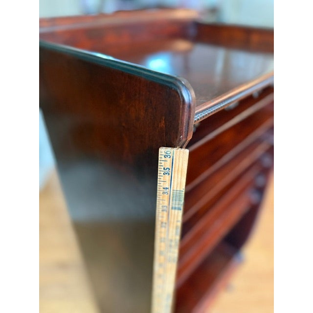 Mahogany wood sheet music cabinet featuring an open front with multiple stepped interior shelves and a lower compartment,...