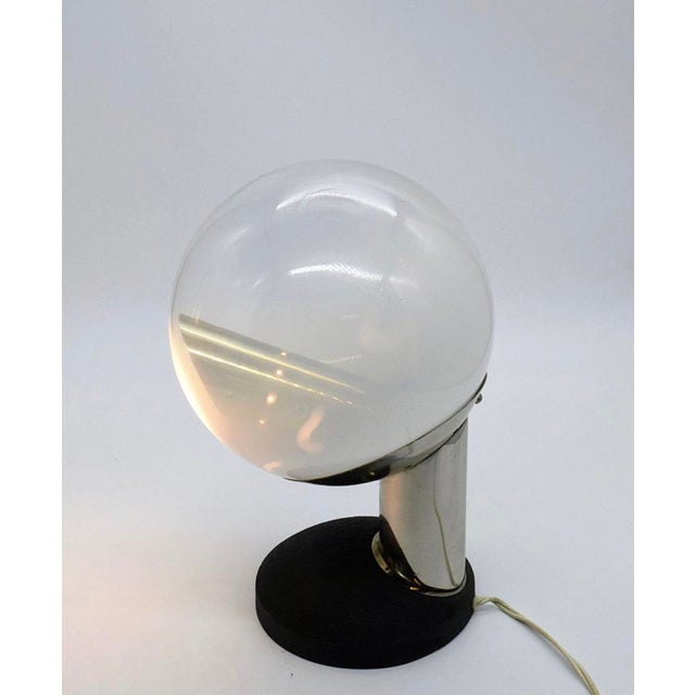 Adjustable table lamp, made in Italy in the 1960s. Heavy cast-iron base that allows the lamp to rotate 360 degrees....