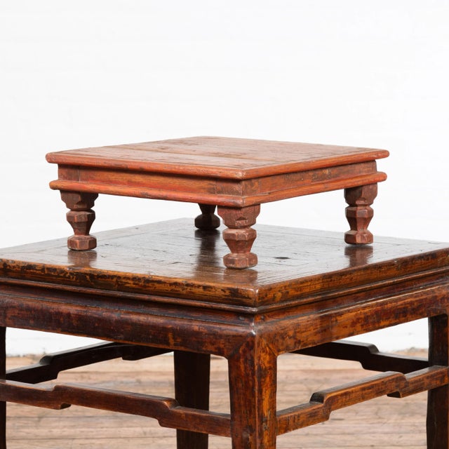 An Indian vintage low wooden prayer table from the mid 20th century, with carved legs. Created in India during the...