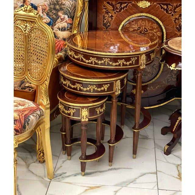 Bring timeless elegance and versatility to your home with this exquisite Set of Three French Nesting Side Tables....