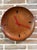Vintage wall clock from the 1960s in Mid-Century Modern style, featuring a refined circular teak wood case in a warm hue...