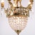 Antique French crystal chandelier from around 1890, designed with prisms and decorative details in gilt bronze. The...
