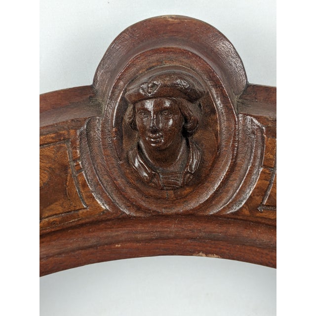 Striking antique Victorian carved wood chair distinguished by its graceful open oval back, sweeping curved arms, richly...