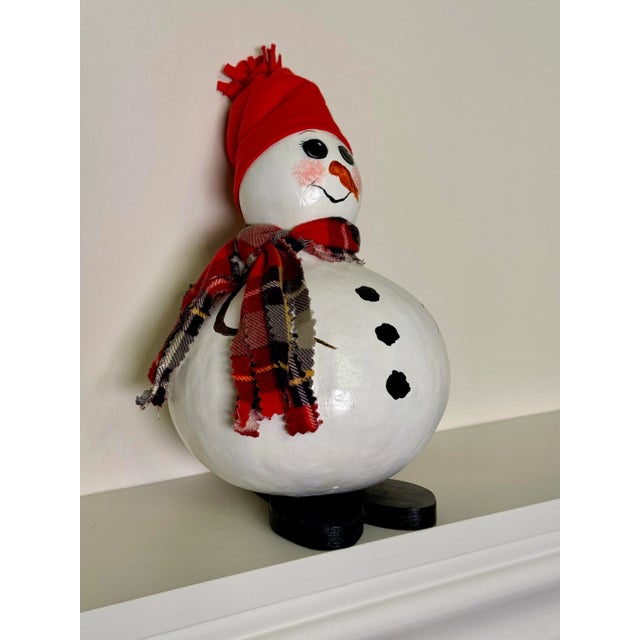 This meticulously hand painted details of the white snowman are painted on a gourd. This hand crafted piece is sure to...