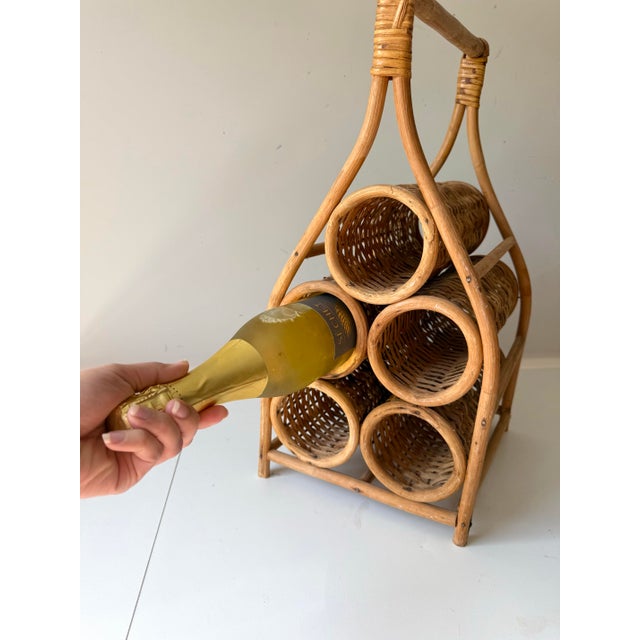 Vintage 1970s era bamboo and rattan free standing wine rack. The piece can hold up to five wine bottles.