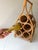 Vintage 1970s era bamboo and rattan free standing wine rack. The piece can hold up to five wine bottles.