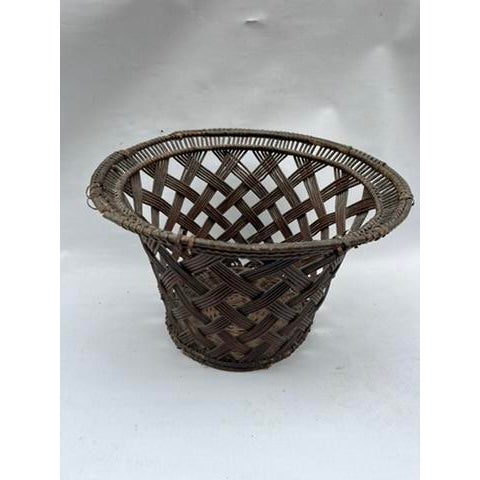 A single large antique woven wicker cachepot or basket featuring flared sides. Interior base 8" diameter.