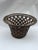 A single large antique woven wicker cachepot or basket featuring flared sides. Interior base 8" diameter.