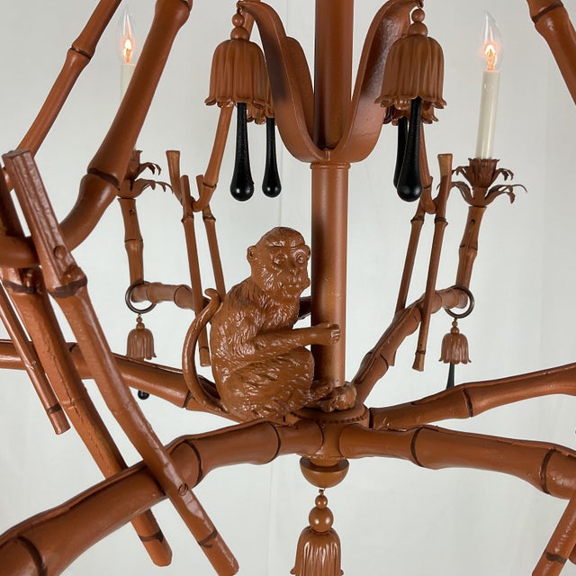 A spectacular and highly decorative Chinoiserie-style chandelier featuring an elaborate faux bamboo framework with a...